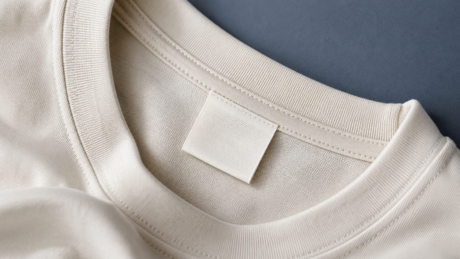 Close-up of the blank inside neck of a cotton t-shirt showing a woven care label